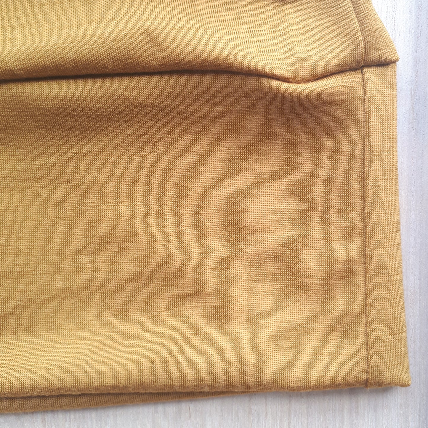 Close up of ochre yellow merino fabric