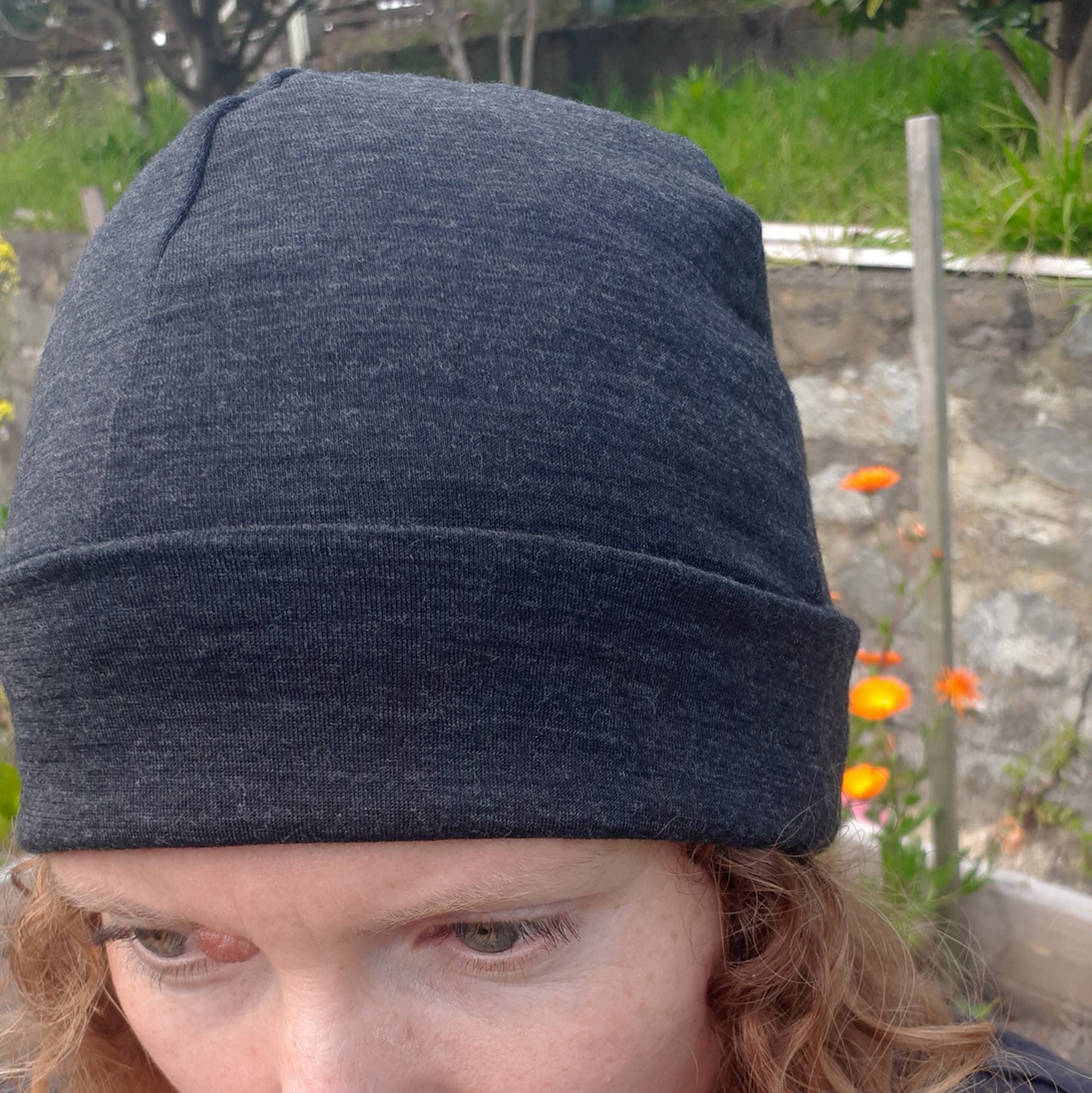 Woman wearing a charcoal merino beanie