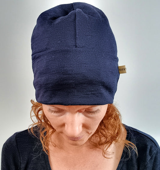 Woman wearing an ink blue merino beanie