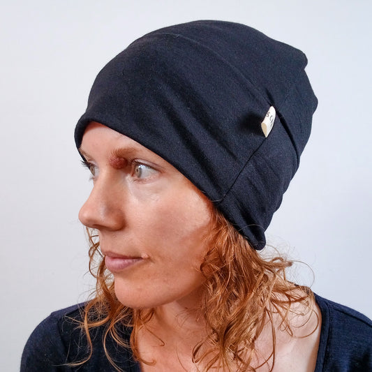 Woman wearing a black merino beanie