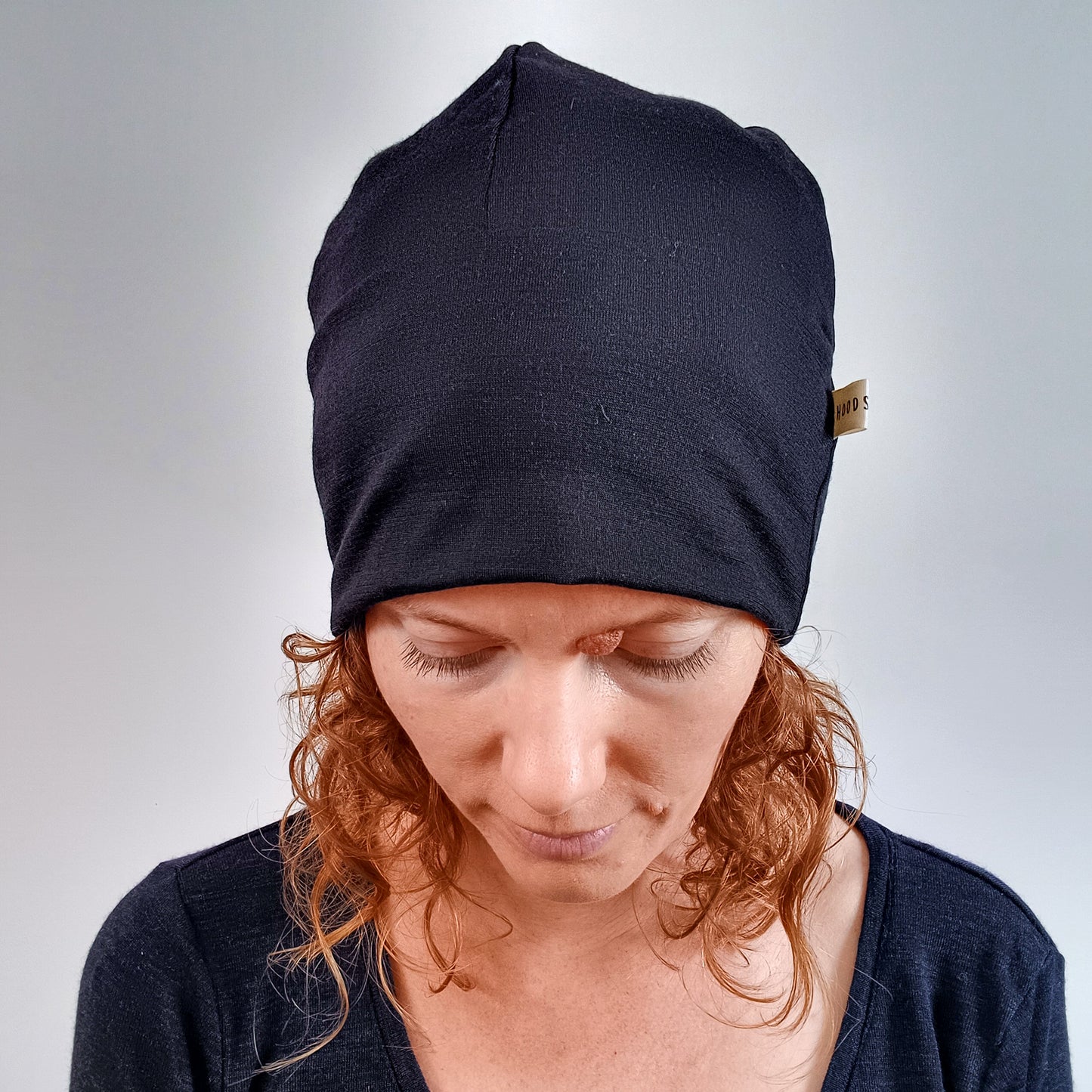 Woman wearing a black merino beanie