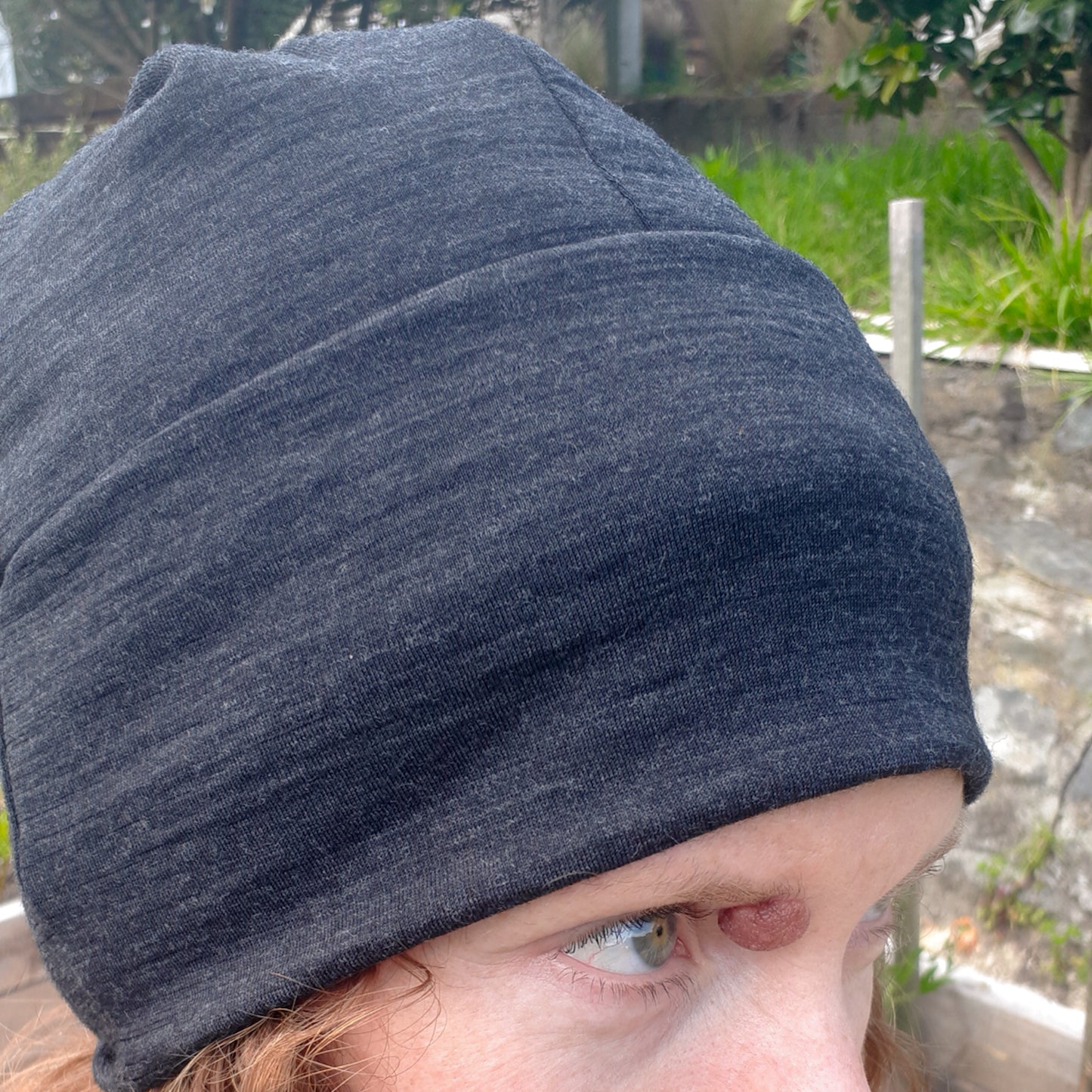 Woman wearing charcoal merino beanie